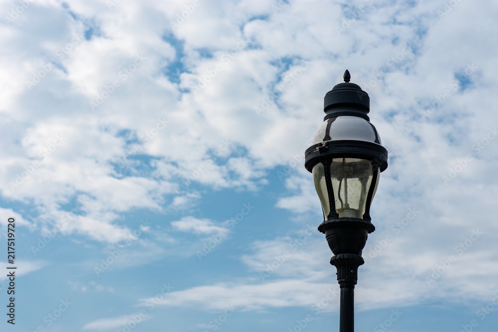 Street light isolated against cloudy blue sky background 