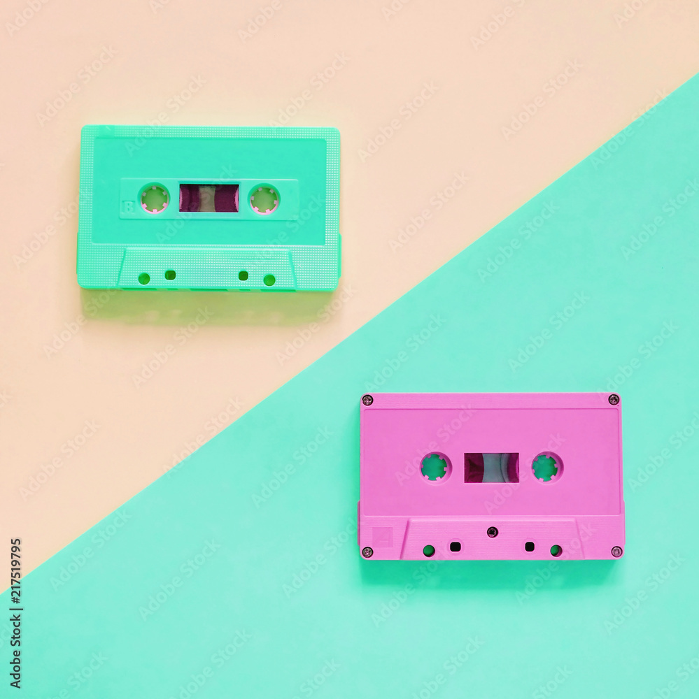 Fototapeta premium Flat lay retro colorful cassette tape on pastel color background, minimal style