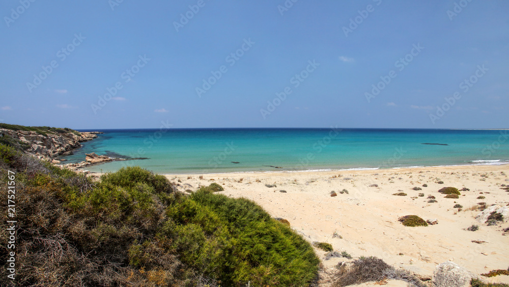 Beautiful empty unspoiled fine sand beach with no people, view from top of the hill to azure calm sea. Karpass (Karpaz) region, northern Cyprus.