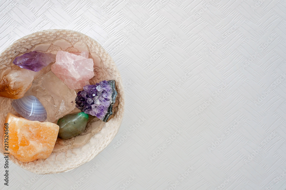 Healing crystals on a white table including: Amethyst Point and Cluster, Clear Quartz, Citrine, Calcite and Rose quartz. Gemstones are full of healing energy and good vibes. Healing crystals on a white table including: Amethyst Point and Cluster, Clear Quartz, Citrine, Calcite and Rose quartz. Gemstones are full of healing energy and good vibes.