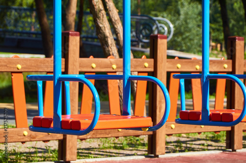 Swing for children in the public playground © Sviatoslav Kovtun