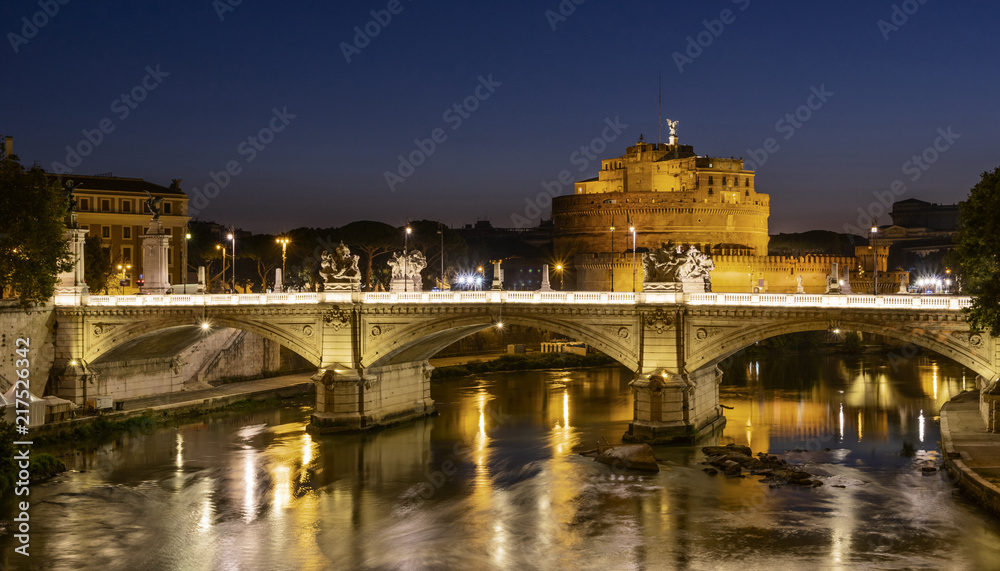 Night view of Rome. There is a bridge over Tiber and Saint Angel Castle in background