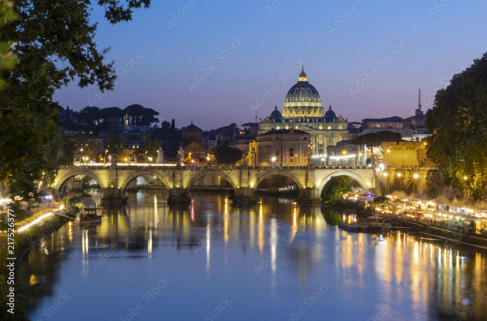 Night view of Rome and St. Peter's Basilica across Tiber river