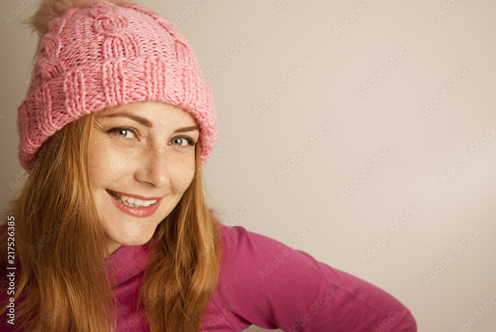 Young blonde woman in pink knitted hat and pink sweater, close up portret. Smiling woman. Winter soon. Isolated. Young blonde woman in pink knitted hat and pink sweater, close up portret. Smiling woman. Winter soon. Isolated.