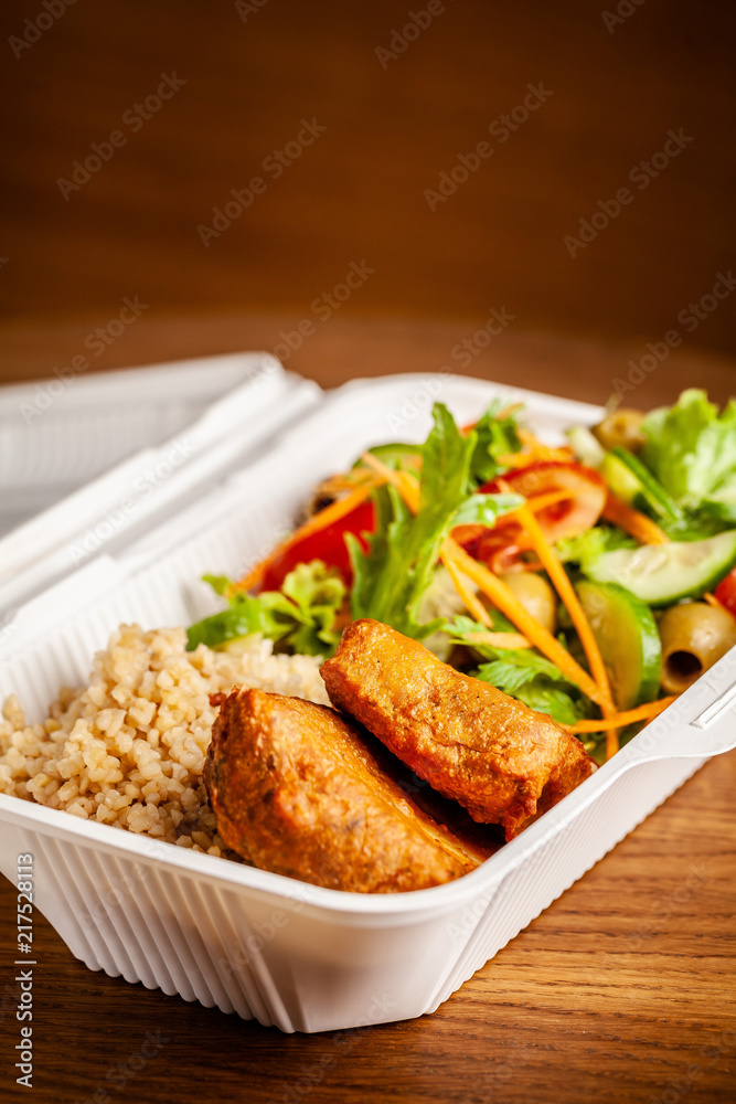 Concept of vegetarian and healthy eating. Cutlets from peas, salad, ogretsami, tomatoes, olives and porridge in eco-box of food starch. self-destructive dishes. Copy space, selective focus Concept of vegetarian and healthy eating. Cutlets from peas, salad, ogretsami, tomatoes, olives and porridge in eco-box of food starch. self-destructive dishes. Copy space, selective focus