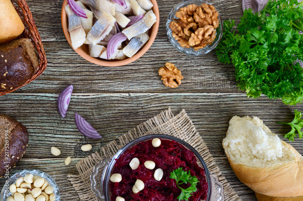 Salad from boiled beets, pieces of herring with red onion, nuts. Top view. Salad from boiled beets, pieces of herring with red onion, nuts. Top view.
