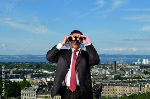 Photography Business Man is spying with Binoculars on Competitors