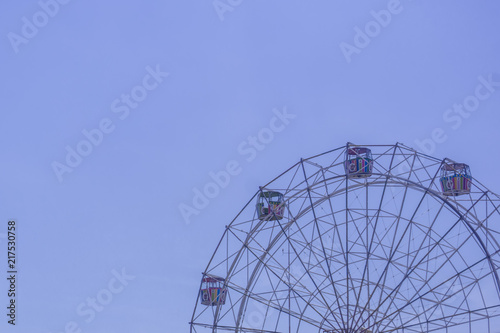 Part of Ferris Wheel with blue sky background