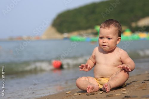 Baby playing on the sandy beach