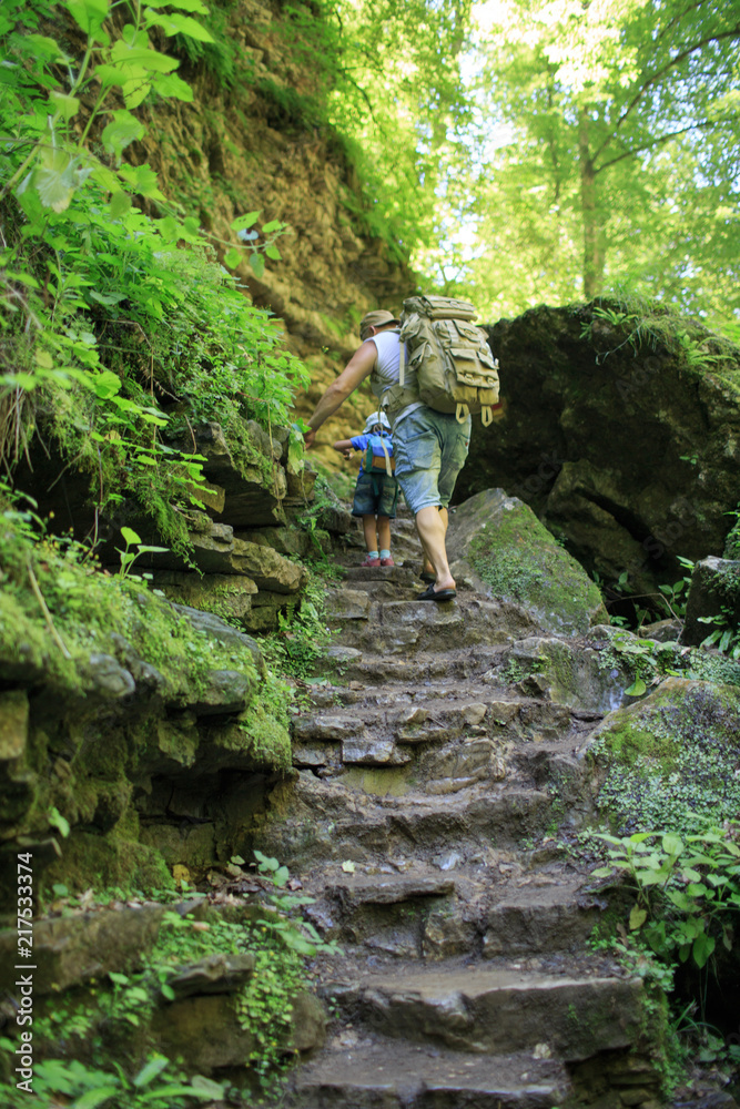 Obraz premium Family walking in a forest