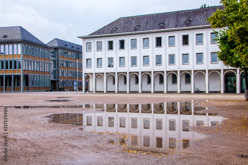 Reflection of houses near the Schlossplatz in Karlsruhe, next to the castle, reflecting in a puddle