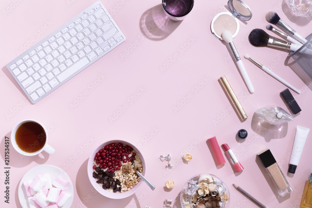 Flat lay with cup of tea or coffee, laptop or computer, woman make up products on pink background, view from above. Flat lay with cup of tea or coffee, laptop or computer, woman make up products on pink background, view from above.