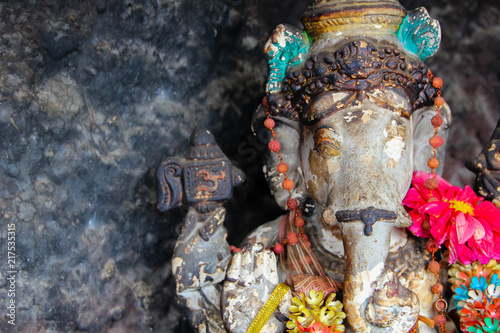 Ancient vishnu elephant god statue with fresh flower as sacrificies in an Indian temple photo