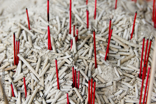 Red burned incents on a temple for praying to the gods photo