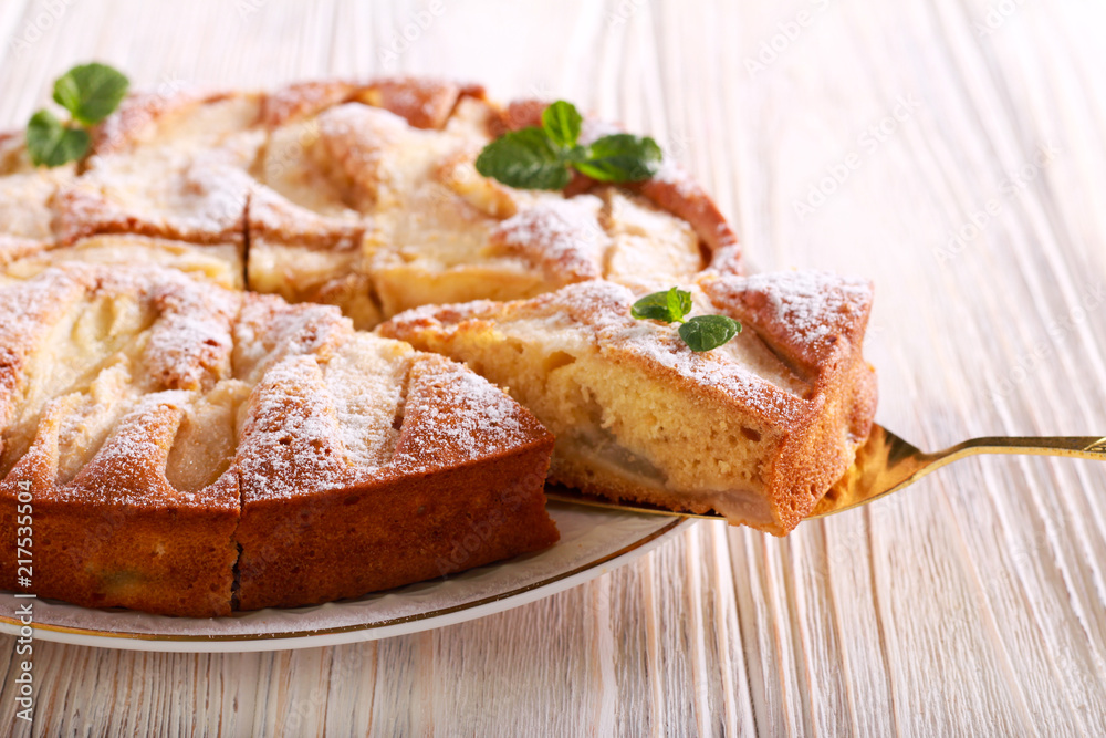 Fruit cake with icing sugar on top, served