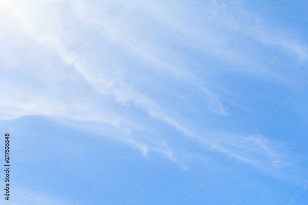 White feather clouds in azure sky as background