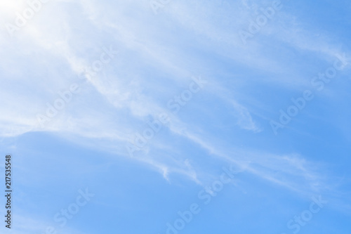 White feather clouds in azure sky as background