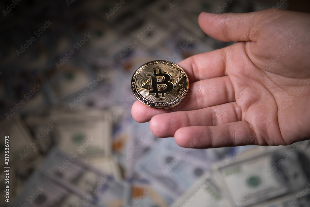 golden bitcoin coin on us dollars close up golden bitcoin coin on us dollars close up