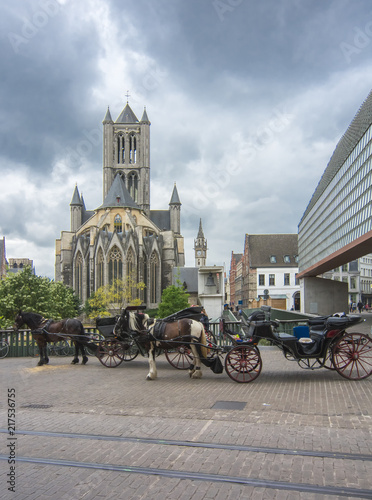 Horse carriage and St. Nicholas church in center of Gent, Belgium