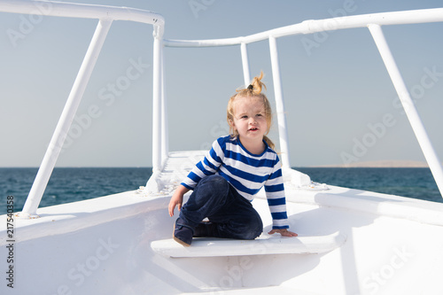 Childhood concept. Little child enjoy sea travel on ship, childhood. Joys of childhood. Childhood experience. Summer vacation and adventure