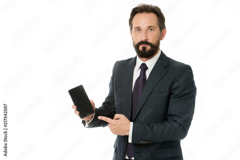 Smartphone concept. Bearded man point finger at smartphone. Business man hold smartphone. Smartphone is what you need Smartphone concept. Bearded man point finger at smartphone. Business man hold smartphone. Smartphone is what you need