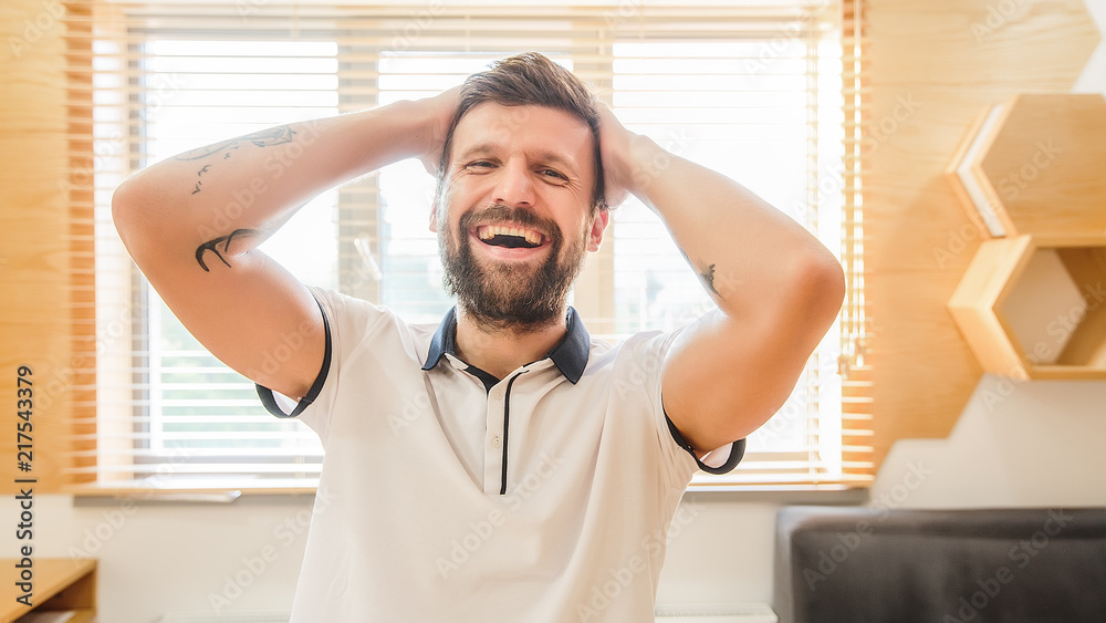 Guy posing on the camera indoor, hipster designer at office, gamer, player in computer games, guy came up new idea, attractive, emotions, surprise Guy posing on the camera indoor, hipster designer at office, gamer, player in computer games, guy came up new idea, attractive, emotions, surprise