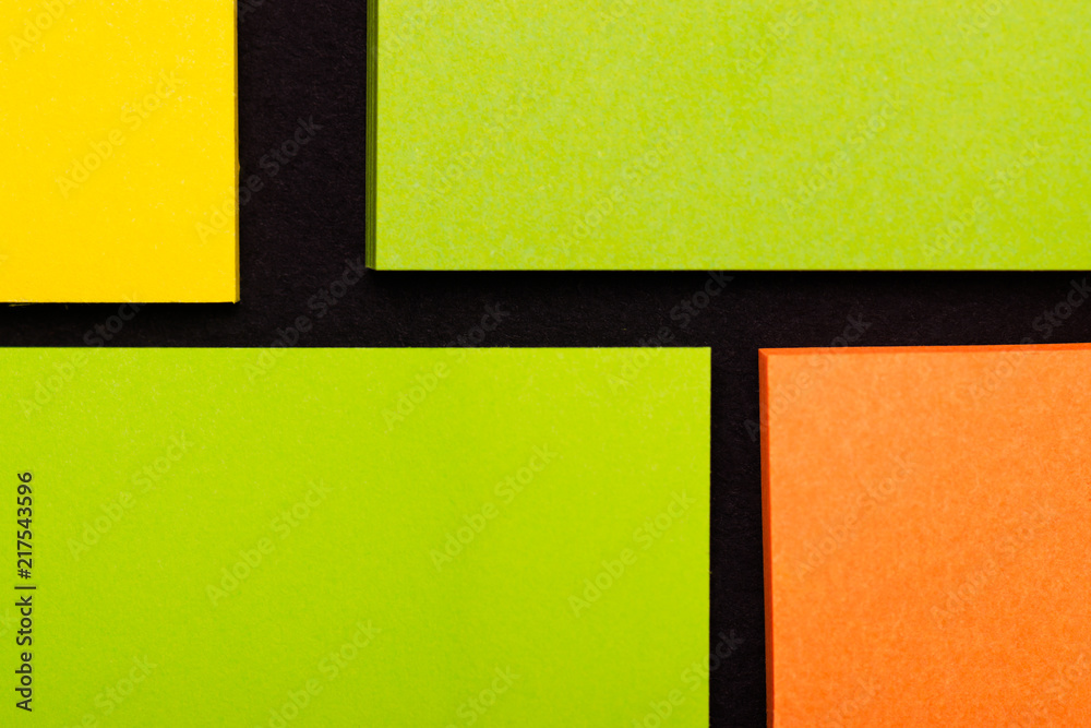 Fototapeta premium Small square sheets for notes. Yellow, green, pink paper.