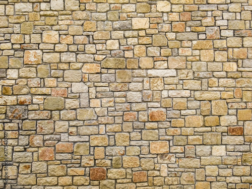 Big stone wall with yellow and orange colors and different shapes