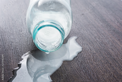 split milk from a bottle on wooden table