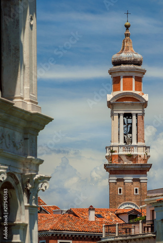 Church of the Holy Apostles of Christ baroque bell tower with clock, built between 17th and 18th century, rise above Venice historic center old buildings
