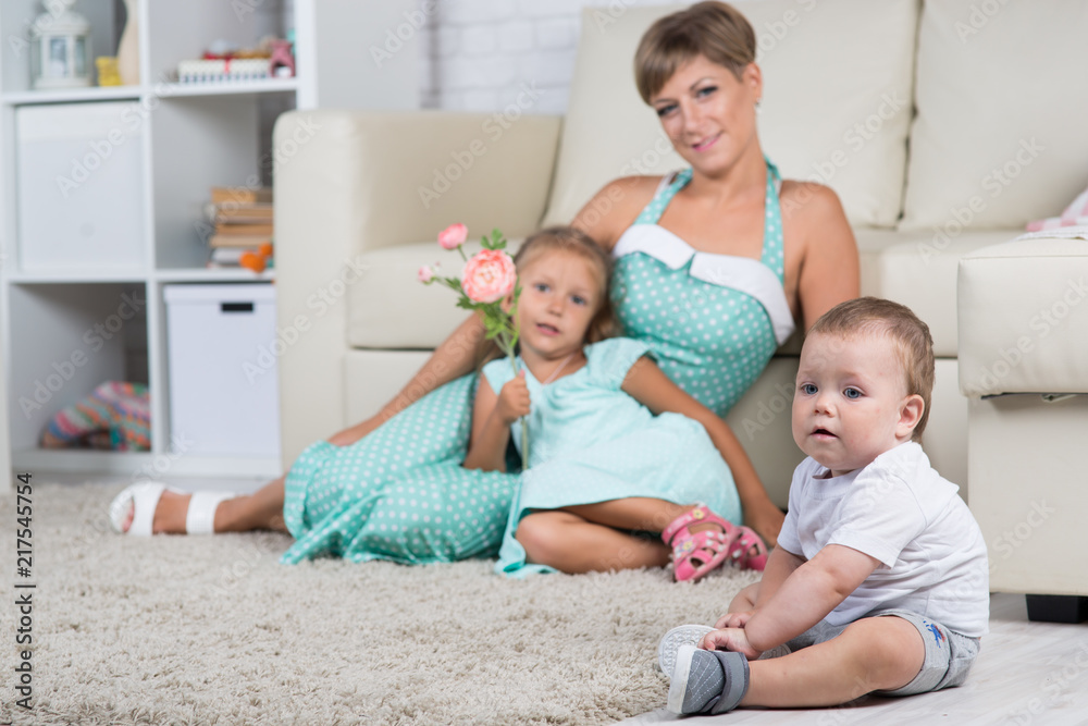 mom with two children playing at home in the room mom with two children playing at home in the room