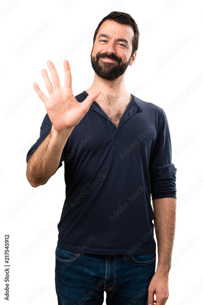Handsome man with beard counting five Handsome man with beard counting five