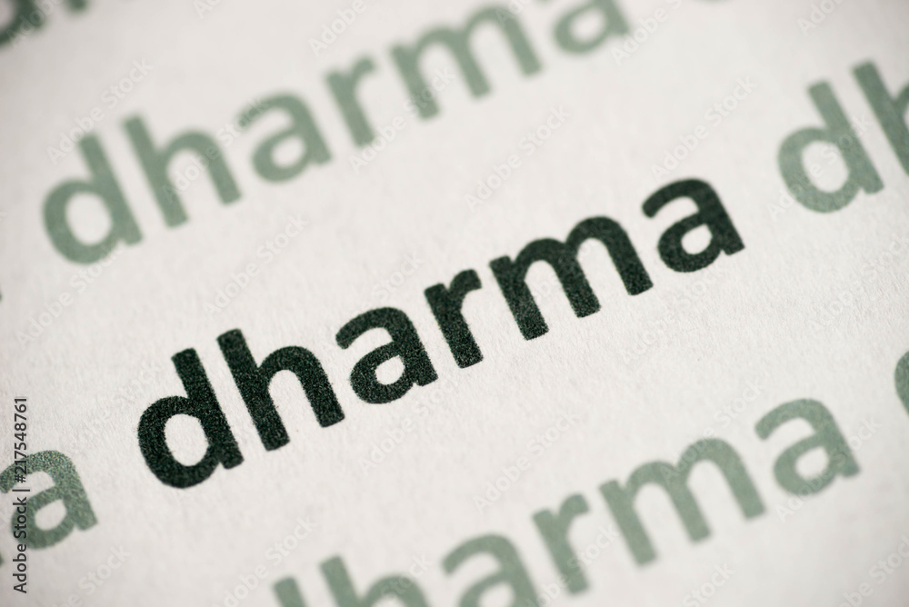 Fototapeta premium word dharma printed on paper macro