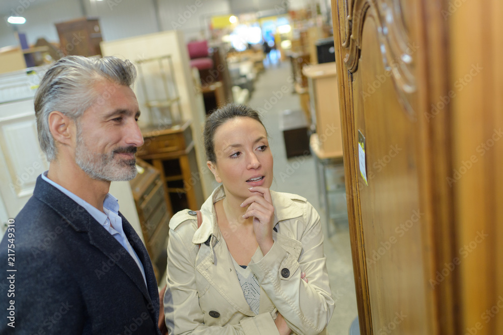 pretty woman with salesman in furniture store pretty woman with salesman in furniture store