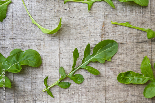 Fresh rucola leaves on the wooden background