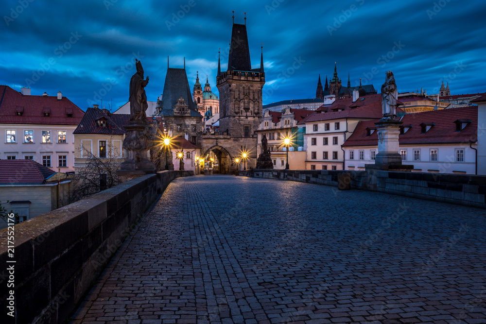 View of the Lesser Bridge Tower of Charles Bridge in Prague at sunrise, Czech Republic, Europe. This bridge is the oldest in the city and a very popular tourist attraction.