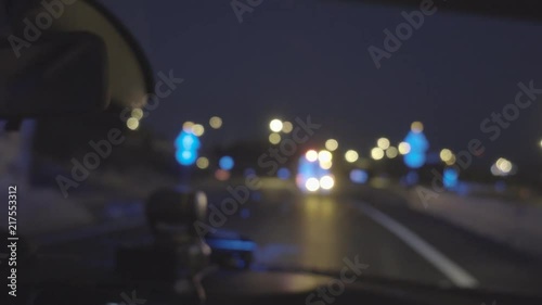 Defocused image of police car interior behind ambulance