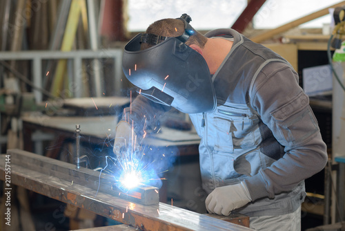 man welds at the factory