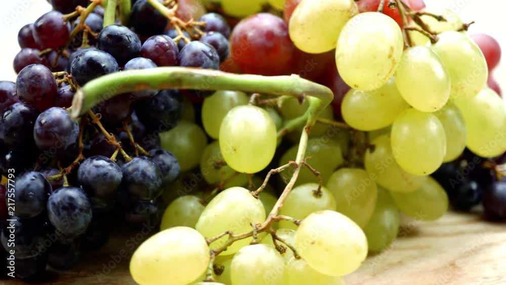 Fresh organic grapes collection with water drops rotating on a turn table. Macro. 4K Fresh organic grapes collection with water drops rotating on a turn table. Macro. 4K