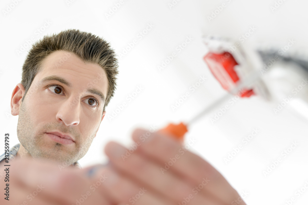 Man using a screwdriver Man using a screwdriver