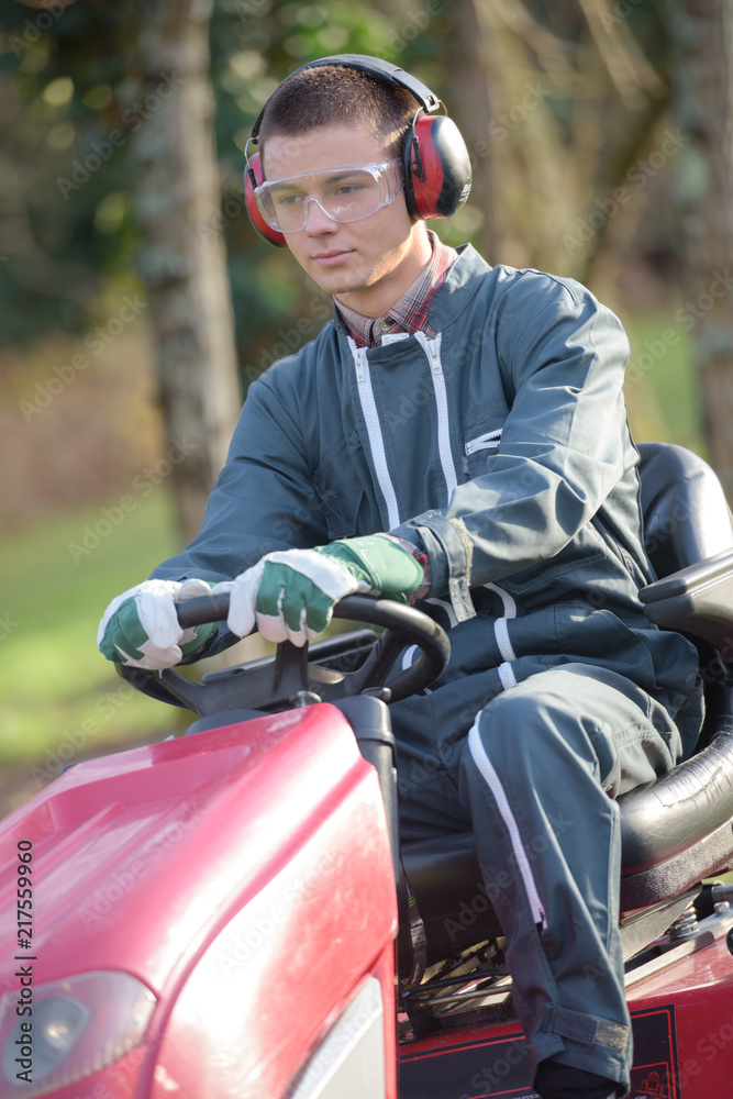 garden caretaker mowing the land