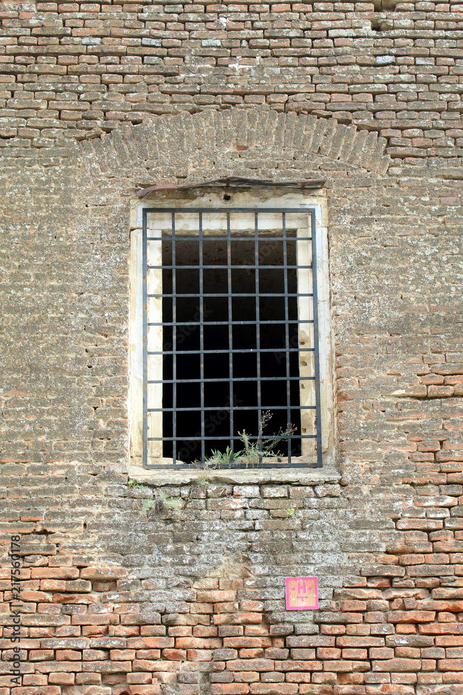 Prison cell wall with a window with bars