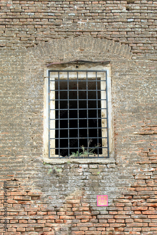 Prison cell wall with a window with bars Prison cell wall with a window with bars