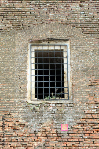 Prison cell wall with a window with bars