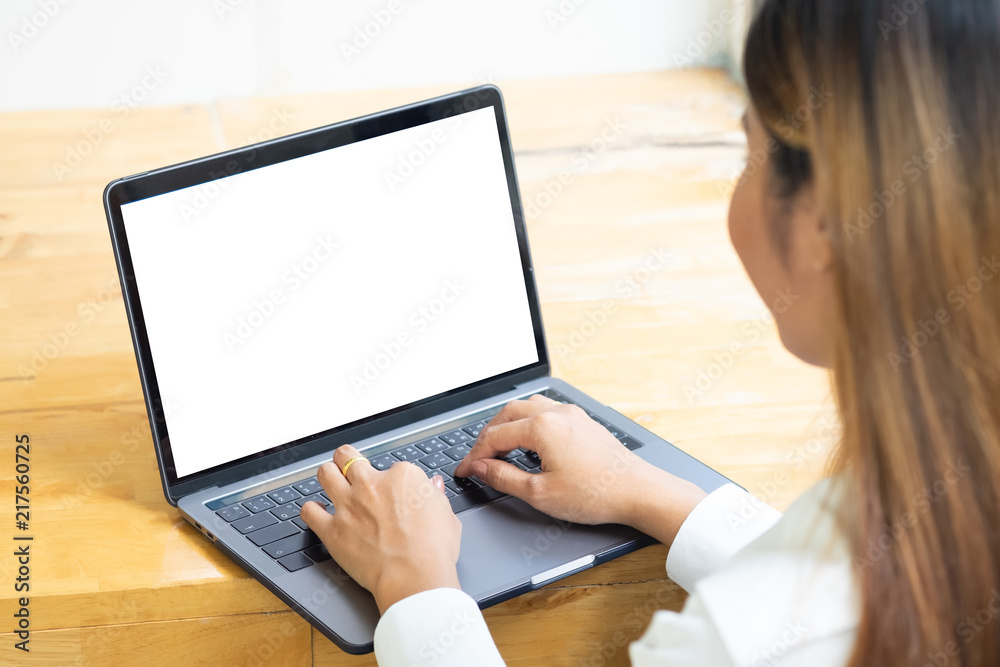 Asian female using laptop computer mock up on wooden table. Asian female using laptop computer mock up on wooden table.