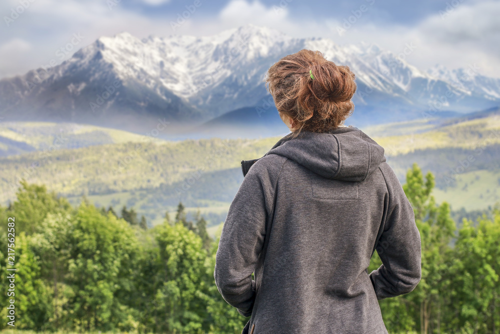 Young woman looking at the mountains.