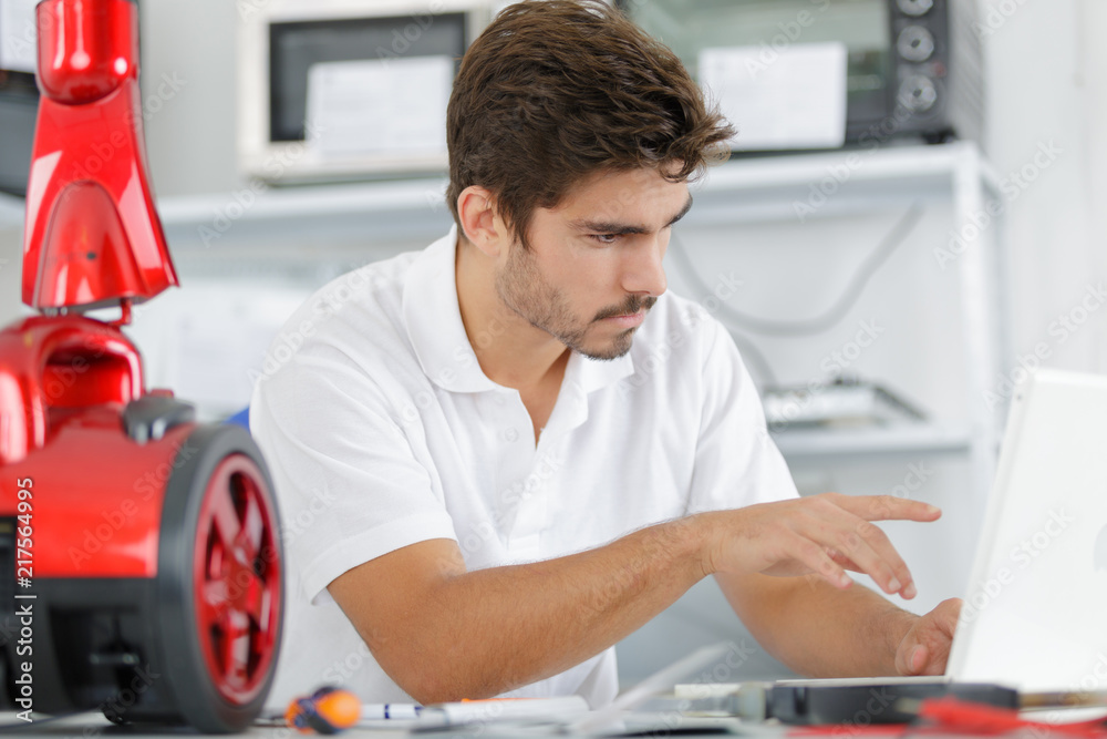 handsome engineer researching manufacturing issues with vacuum cleaner