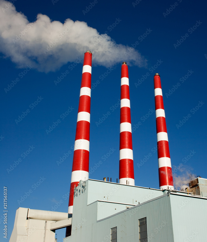 Industrial plant smoke stacks and blue sky. Industrial plant smoke stacks and blue sky.