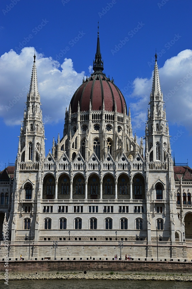 Central part of Hungarian Parliament Building in Budapest during summer, slightly cloudy skies. 
