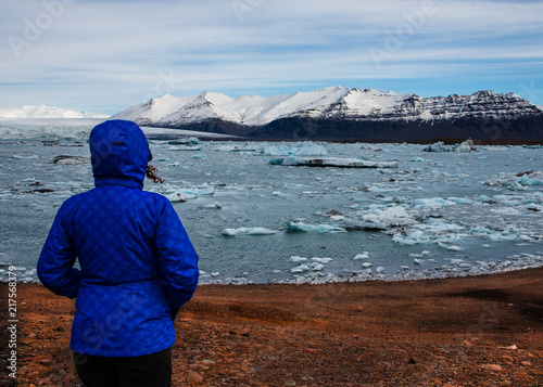 Close-up of hiker with Glacier Lake photo